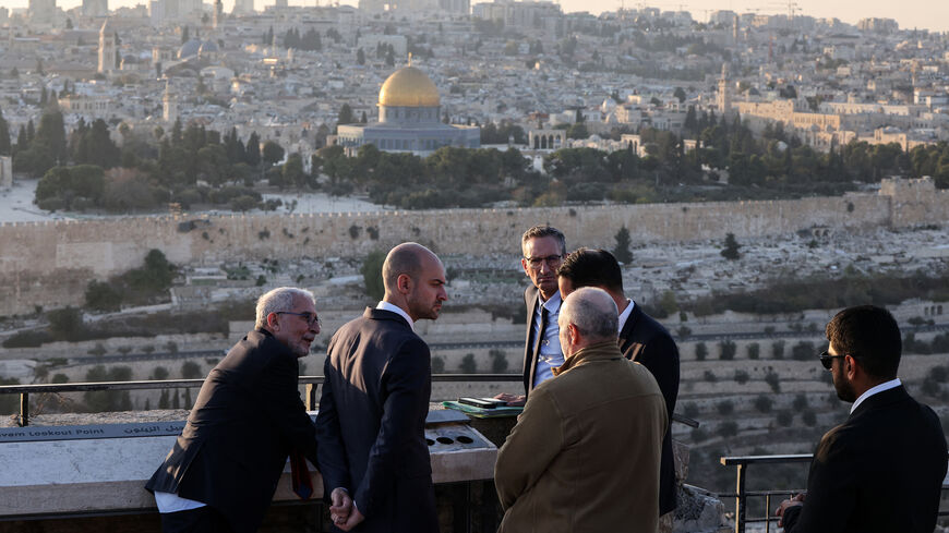 France's Minister for Europe and Foreign Affairs Jean-Noel Barrot (2-R) speaks to members of his delegation as he visits the Mount of Olives, overlooking Jerusalem's Old City and Al-Aqsa Mosque compound, Nov. 7, 2024.