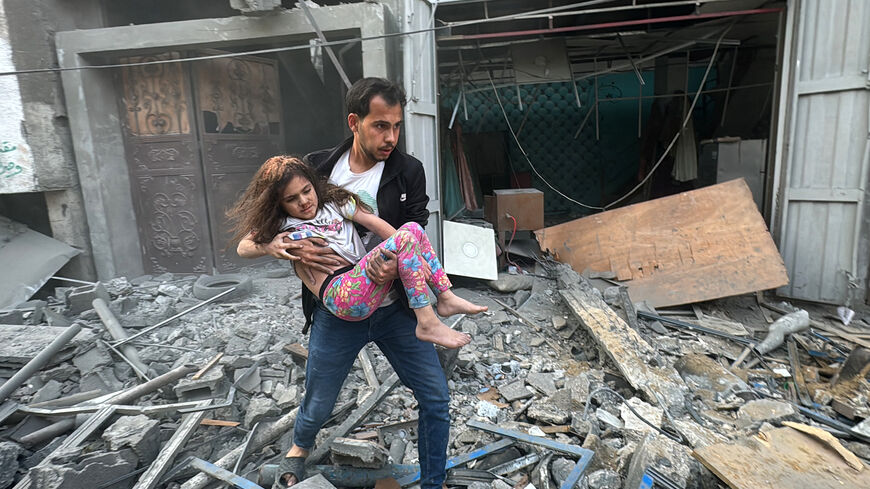 A Palestinian man carries away an injured child from a home that was hit in an Israeli strike on the Jabalia refugee camp in the northern Gaza Strip, on November 7, 2024. Israel's military has been conducting a sweeping air and ground assault in northern Gaza since October 6, 2024, particularly around Jabalia, Beit Lahia and Beit Hanoun, saying it aims to prevent Hamas regrouping. (Photo by AFP) (Photo by -/AFP via Getty Images)