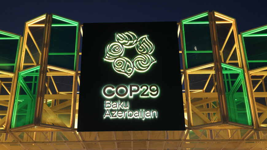 The entrance gate stands illuminated outside the conference venue prior to the COP29 Climate Conference, Baku, Azerbaijan, Nov. 10, 2024.