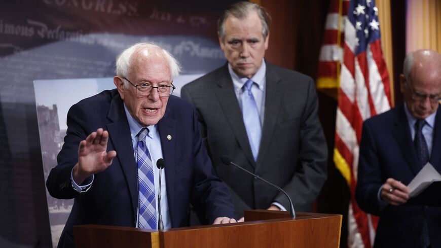 US Sen. Bernie Sanders, joined by fellow US Sens. Chris Van Hollen, Jeff Merkley and Peter Welch, listens to a question at a news conference on restricting arms sales to Israel at the US Capitol on Nov. 19, 2024, in Washington, DC. 