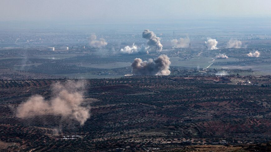 Smoke billows from the site of clashes and mutual shelling between Syrian jihadists and allied factions and regime forces on the front lines on the outskirts of the city of Saraqib, in Aleppo province, on Nov. 28, 2024.