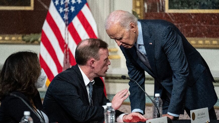 US President Joe Biden confers with his National Security Advisor Jake Sullivan in Washington on October 11, 2023 