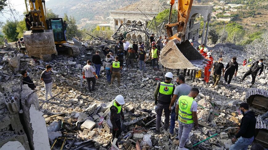 Rescuers search at the site of a deadly Israeli air strike that targeted the village of Almat, north of Beirut