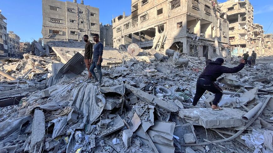 People inspect the rubble of a building hit in an overnight Israeli strike in Beit Lahia in the northern Gaza Strip