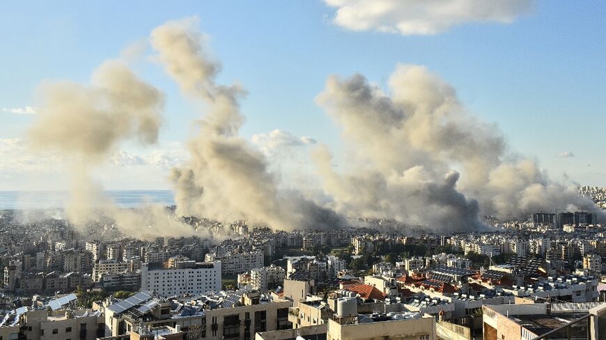 Smoke billows above Beirut's southern suburbs during a spate of Israeli air strikes on Tuesday