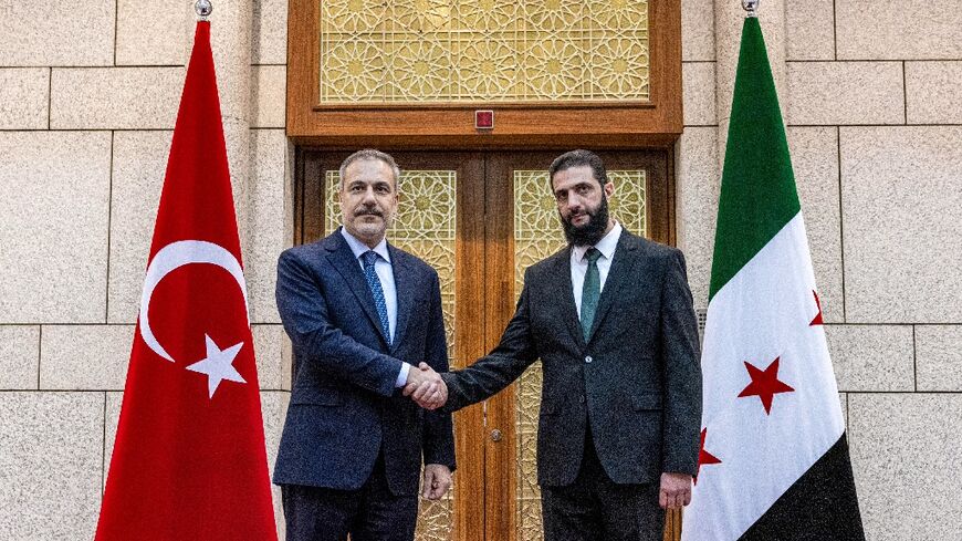 During a press conference with Turkey's Foreign Minister Hakan Fidan (L), Syria's new leader Ahmed al-Sharaa (R) said all weapons must be under state control, including those from 'revolutionary' and Kurdish-led factions