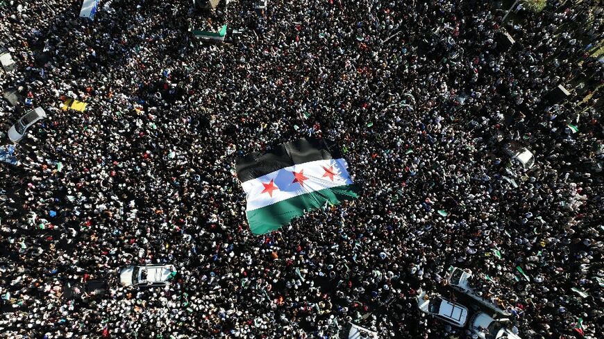 Syria's independence-era flag ripples across a mass rally in Damascus