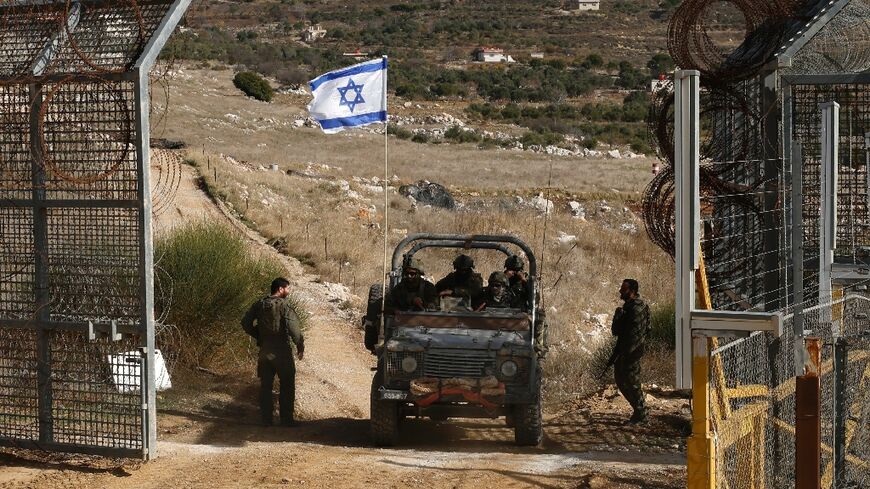 An Israeli jeep returns from a foray into the UN-patrolled buffer zone along the 1974 armistice line with Syrian forces on the Golan Heights.