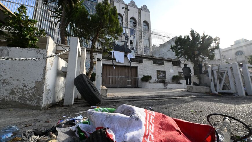 An Iranian flag lies on the pavement outside the embassy in Damascus after it was ransacked during the rebels' capture of the Syrian capital on Sunday