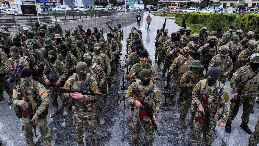 Fighters affiliated with Syria's new administration at a military parade in Damascus