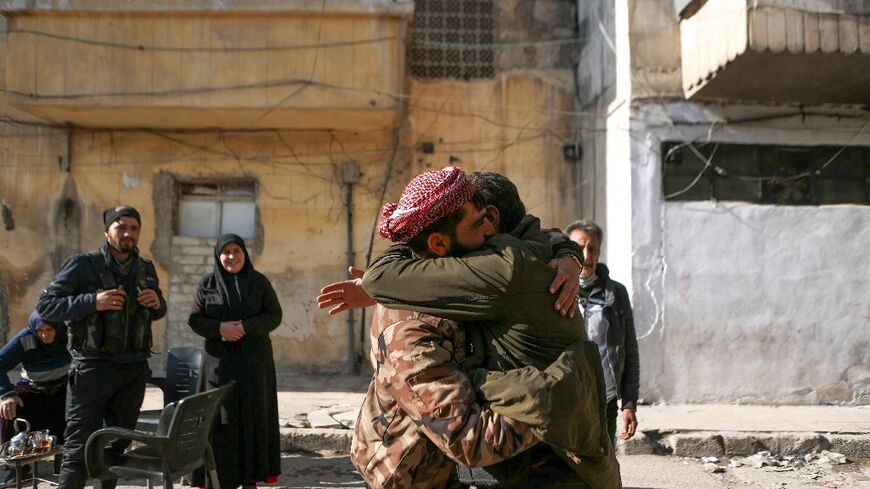 Bahria Bakkur watches on as her son, Mohammed Jomaa, hugs a relative after years of separation