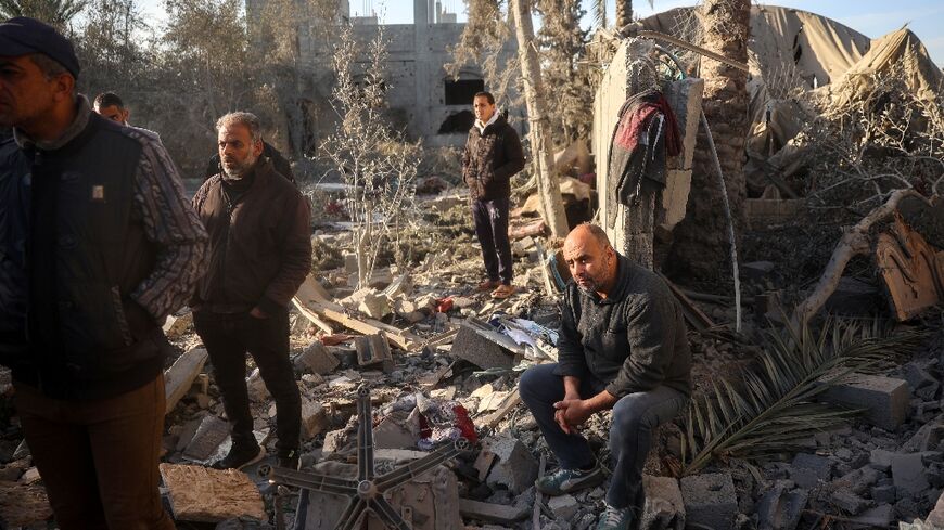 A relative of Abu Samra family looks on as Palestinians search for survivors after a strike on their home in central Gaza