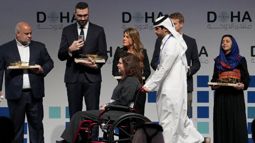 AFP's Christina Assi arriving to receive her award at the Doha Forum in Qatar