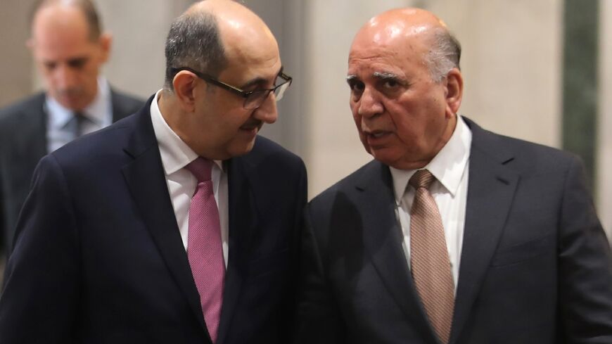 Iraq's Foreign Minister Fuad Hussein welcomes his Syrian counterpart Bassam al-Sabbagh ahead of a meeting in Baghdad