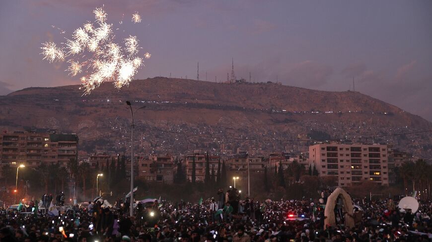 Fireworks errupt as Syrians gather to celebrate the ousting of president Bashar al-Assad at Umayyad Square in the capital Damascus, nearly two weeks after his overthrow