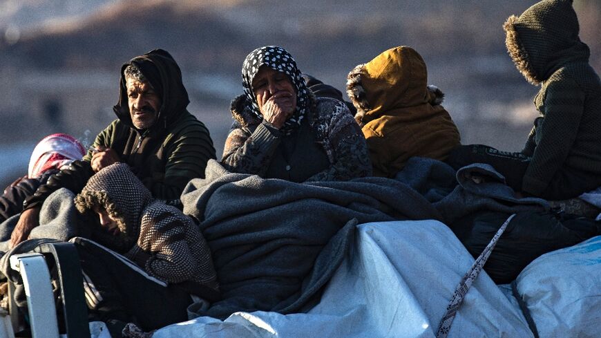 Syrian Kurds flee with what belongings they can carry after Islamist-led rebels overran their homes on the outskirts of Aleppo.