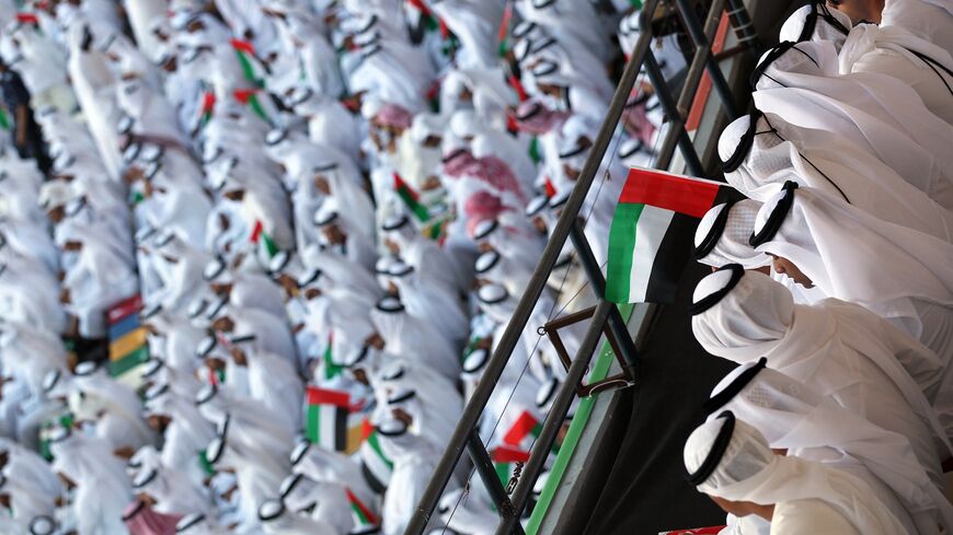 Emiratis wave national flags as citizens celebrate their country's 40 years of independence on National Day, in Abu Dhabi, on Dec. 2, 2011.