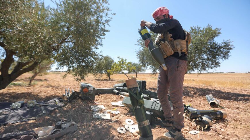 A fighter prepares mortar ammunition as Turkish-supported forces deploy on the Buwayhij-Boughaz-Korhoyuk frontline on the outskirts of Manbij in northeastern Syria, as they fight with the Kurdish-led Syrian Democratic Forces (SDF) on Sept. 6, 2023. 