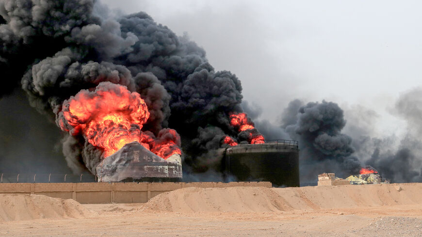 Thick smoke billows from a raging fire at oil storage tanks a day after Israeli strikes on the port of Yemen's Huthi-held city of Hodeida on July 21, 2024. Yemen's Huthi rebels on July 21 promised a "huge" retaliation against Israel following a deadly strike on the port of Hodeida, as regional fallout widens from months of war in Gaza. (Photo by AFP) (Photo by -/AFP via Getty Images)