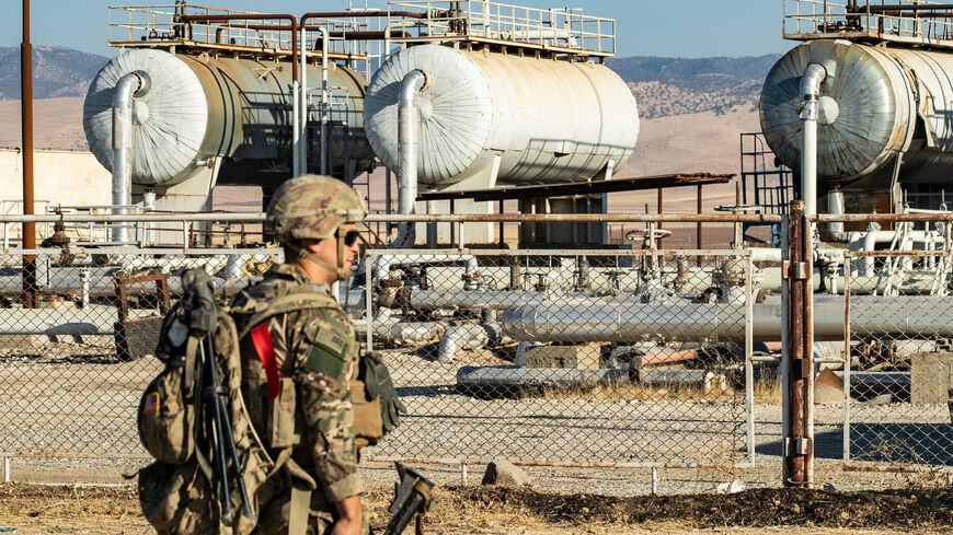 A US soldier stands guard outside an oild field as troops patrol the area near Syria's northeastern border with Turkey in the Qahtaniyah countryside in the far northeast corner of Hasakeh province on Sept. 3, 2024. 