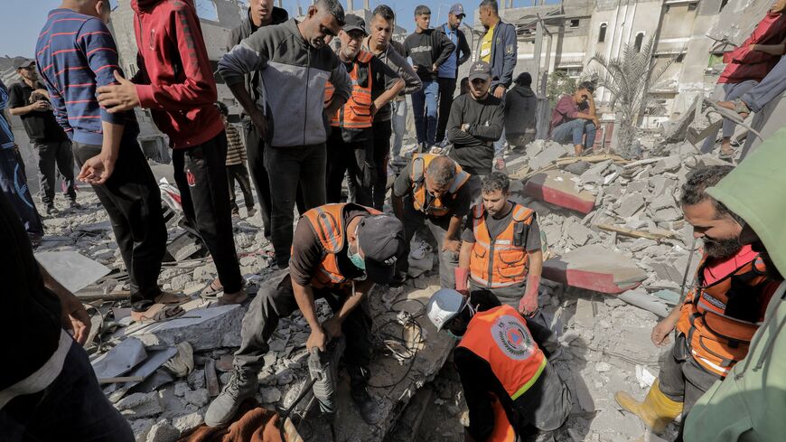 Rescue workers and civilians search through rubble in Gaza on Nov. 7, 2024, after an Israeli airstrike left devastation in a residential area. 