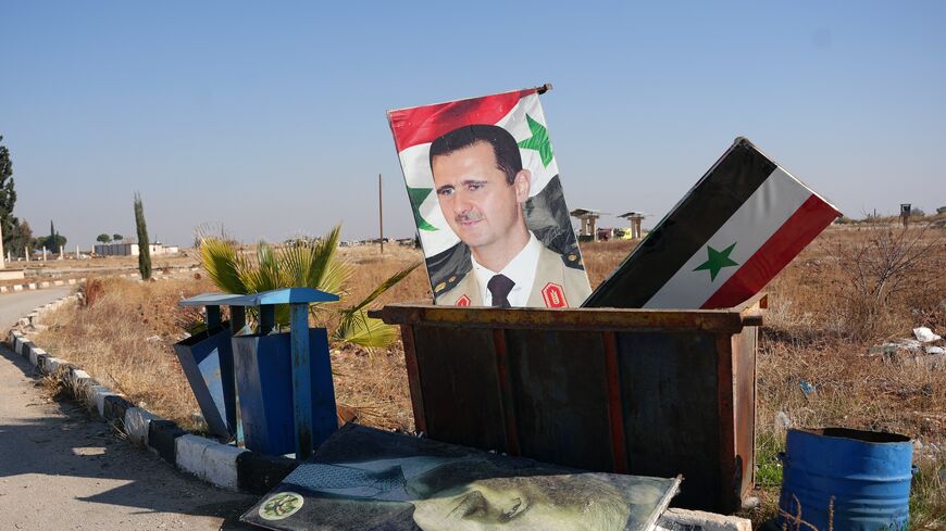  picture taken at the entrance of the Kweyris military airfield in the eastern part of Aleppo province, on Dec. 3, 2024, shows a portrait of Syria's President Bashar al-Assad.