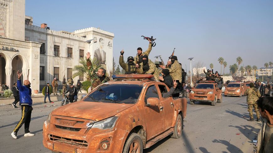 Syrian anti government fighters celebrate as they pour into the captured central-west city of Hama on Dec. 6, 2024.