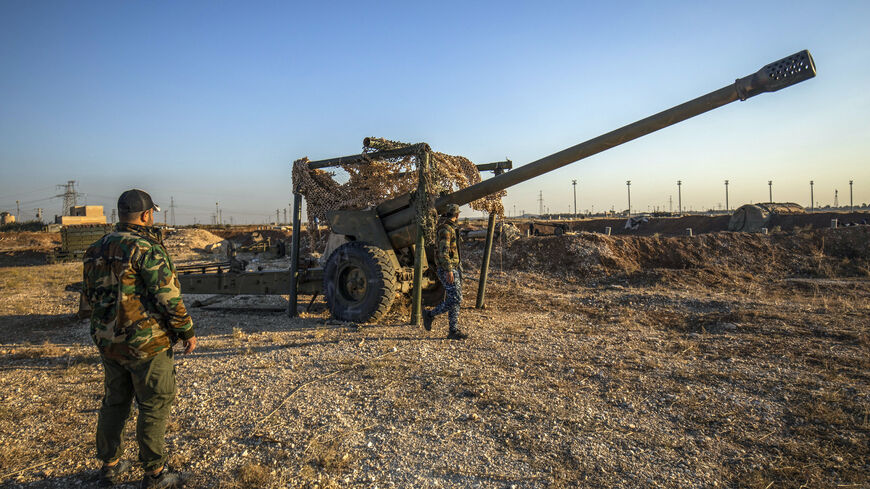 Fighters with the Kurdish-led Syrian Democratic Forces (SDF) inspect damaged and abandoned military vehicles and equipment at the Qamishli international airport, formerly a joint Syrian-russian military base, in northeastern Syria's city of Qamishli on Dec. 9, 2024. 