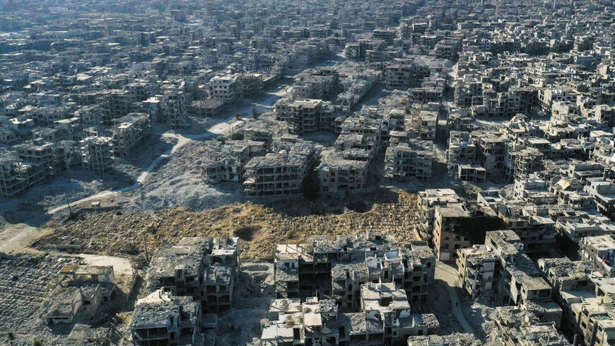 An aerial picture shows a view the destruction at the Yarmouk camp for Palestinian refugees and its cemetery, in the south of Damascus on December 14, 2024. Islamist-led rebels took Damascus in a lightning offensive on December 8, ousting president Bashar al-Assad and ending five decades of Baath rule in Syria. (Photo by Aris MESSINIS / AFP) (Photo by ARIS MESSINIS/AFP via Getty Images)