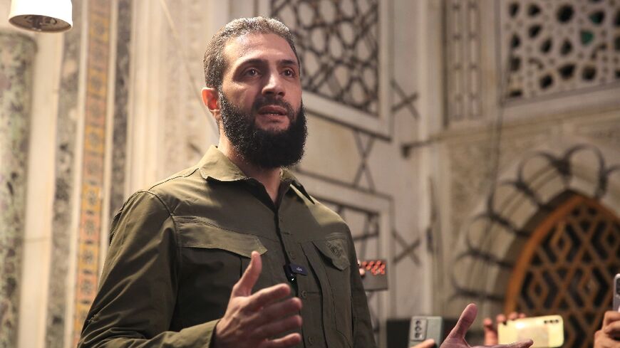 The leader of Syria's Islamist Hayat Tahrir al-Sham group that headed a lightning rebel offensive snatching Damascus from government control, Abu Mohammed al-Jolani, address a crowd at the capital's landmark Umayyad Mosque on December 8, 2024