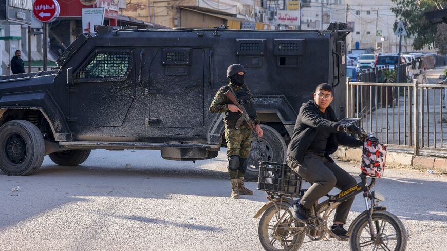 Palestinian security forces man a roadblock in the Israeli-occupied West Bank city of Jenin on December 6, 2024