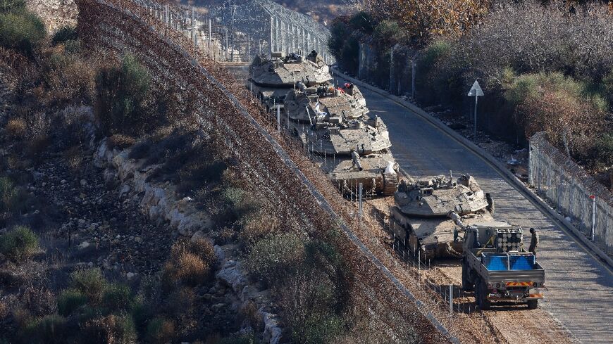 Israeli tanks take position on the border with Syria on the day Benjamin Netanyahu said he ordered the seizure of a buffer zone