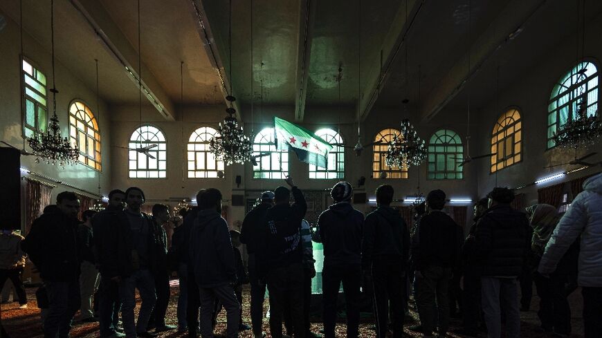 Mourners hold a funeral for Syrian activist Mazen al-Hamada