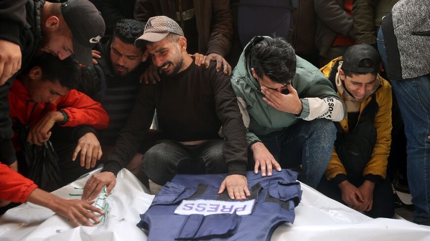 Mourners at the funeral of Al-Quds Today journalists killed in a strike in central Gaza, which Israel says targeted militants