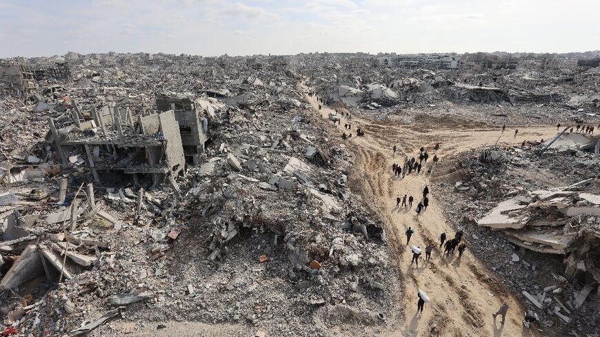 Displaced Palestinians return to the war-devastated Jabalia refugee camp in northern Gaza, shortly before the truce took effect