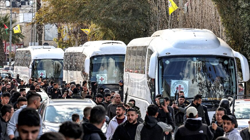 ICRC buses carrying Palestinian prisoners released by Israel driving through the town of Beitunia near Ramallah