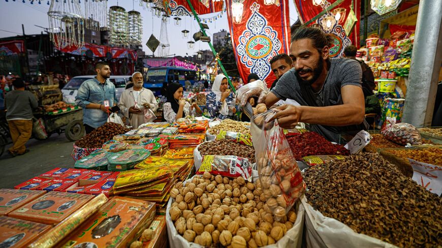 A vendor sells dates and dried fruits at a market in Cairo's central Sayyida Zeinab district, March 12, 2023.