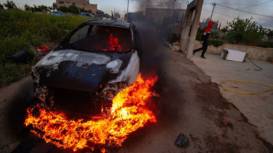 A car belonging to Palestinian villagers set on fire during clashes after the Israeli settlers stormed the village of Qusra in the Israeli-occupied West Bank on Saturday, April 13, 2024. (Photo by Wahaj Bani Moufleh / Middle East Images / Middle East Images via AFP) (Photo by WAHAJ BANI MOUFLEH/Middle East Images/AFP via Getty Images)