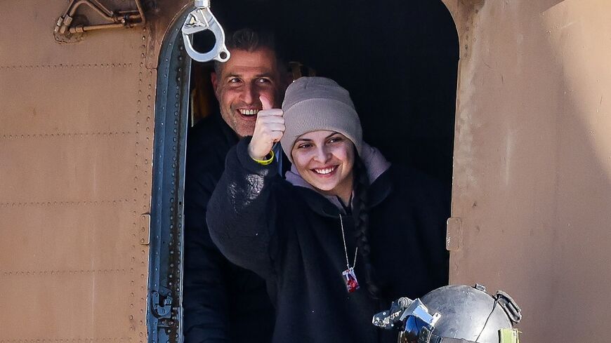 Newly released Israeli hostage Daniella Gilboa, gestures as she leaves a military helicopter upon landing at the Beilinson Hospital in Petah Tikva 