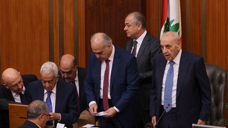 Lebanon's parliamentary speaker Nabih Berri (R) stands with lawmakers as they count votes in the session to elect a president