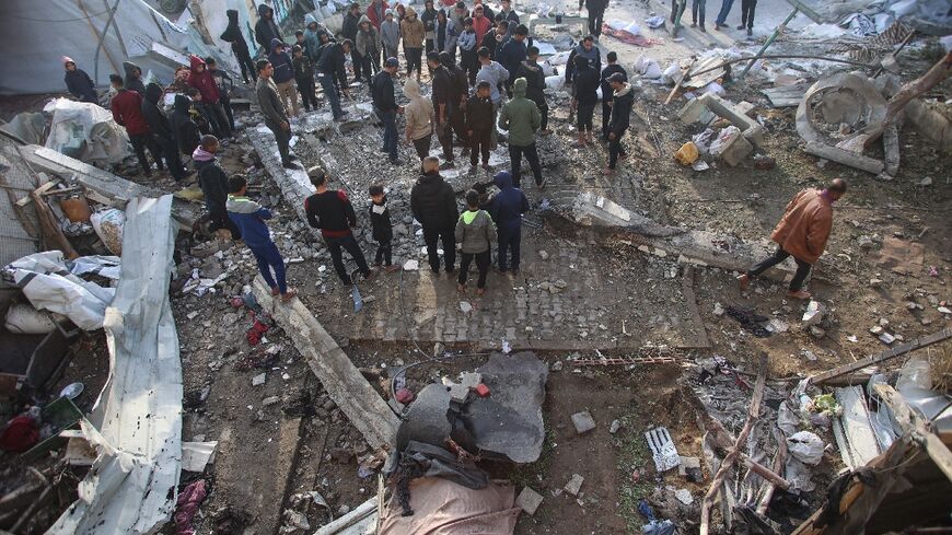 Palestinians at the site of an Israeli strike on a school turned shelter in Gaza City