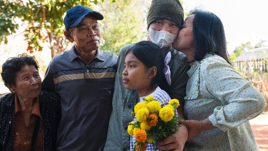 Freed Thai farm worker Watchara Sriaoun, held hostage in Gaza for more than a year, is greeted by his family on his return to his hometown in northeastern Thailand's Udon Thani province