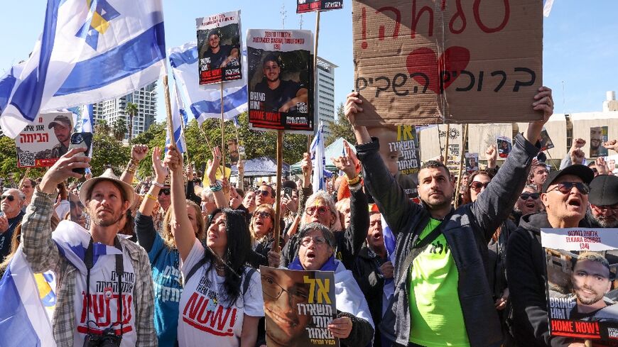 People gather at Tel Aviv's "Hostages Square" to watch the release of three Israelis held by Palestinian militants in Gaza