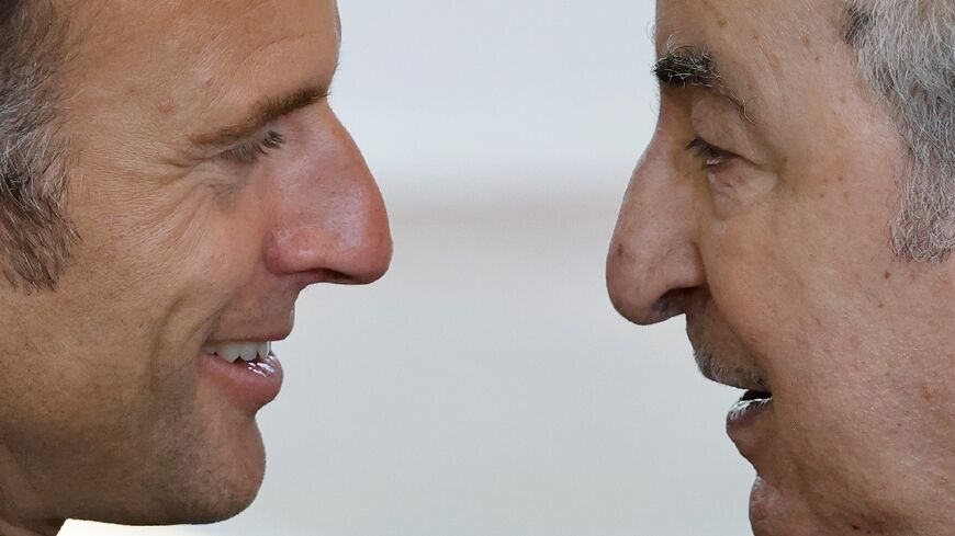 French President Emmanuel Macron (L) meets his Algerian counterpart Abdelmadjid Tebboune on the sidelines of a G7 summit in Italy in June.