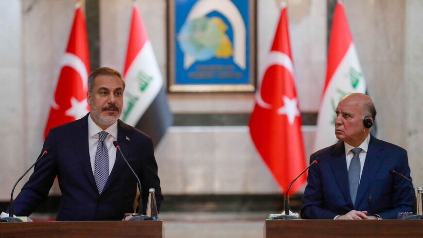 Turkey's Foreign Minister Hakan Fidan (L) speaks during a joint press conference with Iraq's Foreign Minister Fuad Hussein (R), Baghdad, Iraq, Aug. 22, 2023.