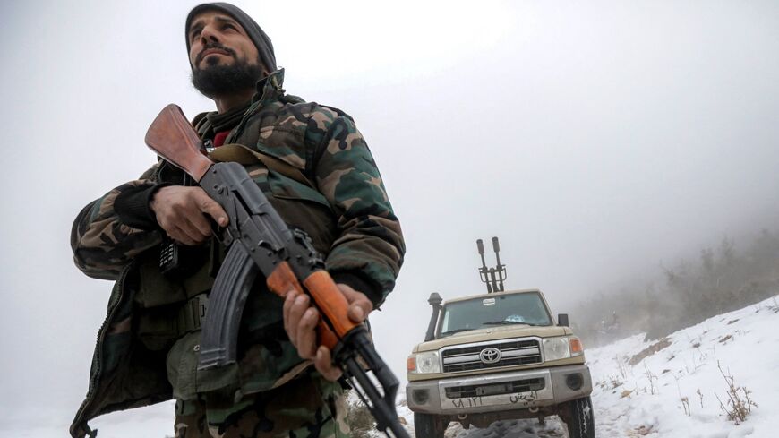 Fighters loyal to the interim Syrian government deploy at a position along the Anti-Lebanon mountain range near al-Qusayr.