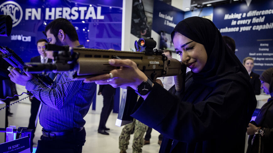 Visitors check weapons during the International Defence Exhibition Idex 2025, on February 17, 2025, in Abu Dhai. (Photo by FADEL SENNA / AFP) (Photo by FADEL SENNA/AFP via Getty Images)