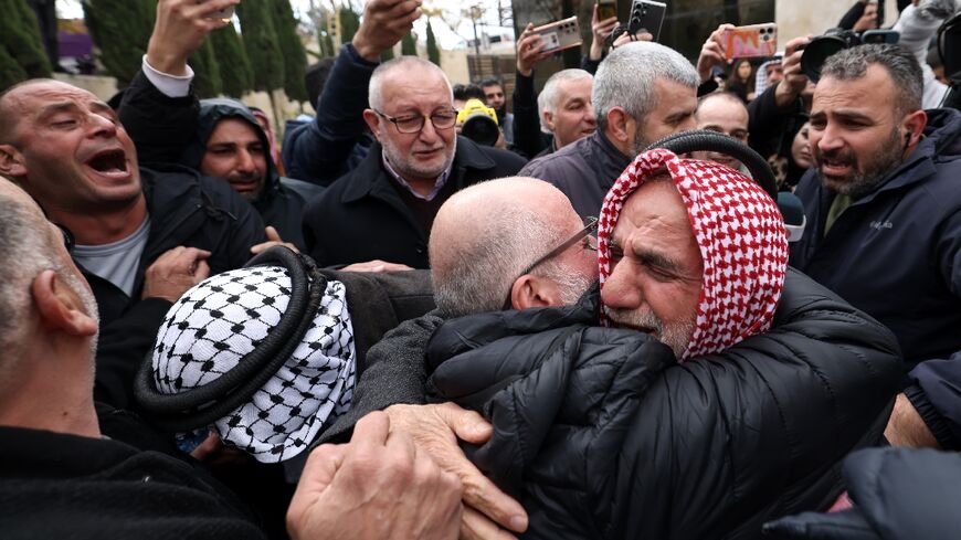 A former Palestinian prisoner hugs a member of his family in the occupied West Bank city of Ramallah following his release from an Israeli prison