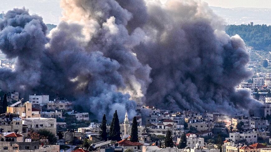 Smoke billows from the site of several explosions during an Israeli raid in the occupied West Bank city of Jenin