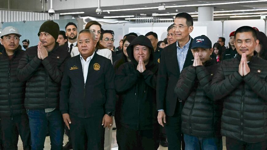 The five freed Thai farm workers arrived Sunday in Bangkok